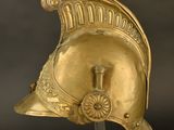 an image of a gold helmet on a stand against a black background