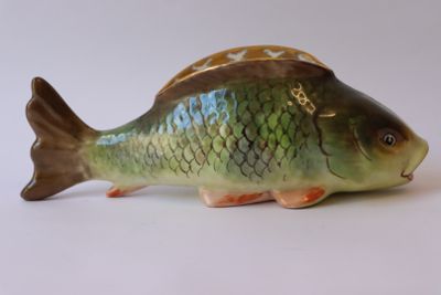 une petite figurine de poisson posée sur une table