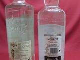 two bottles of vodka sitting next to each other on a table