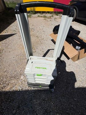 a cart that is sitting on the ground next to a car