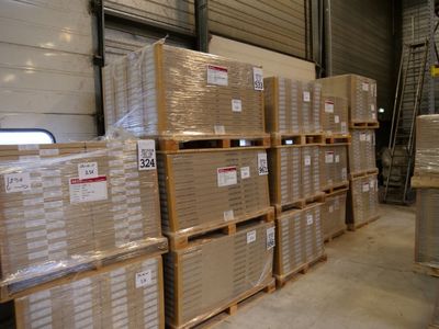 many boxes stacked on pallets in a warehouse