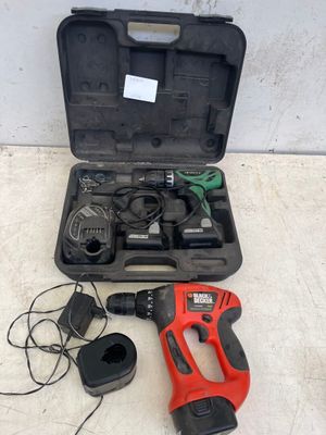 a corded drill in a case with other tools