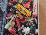 a box full of assorted toy cars and trucks