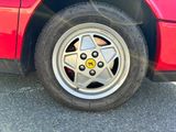 a close up of a red car with a star on the wheel