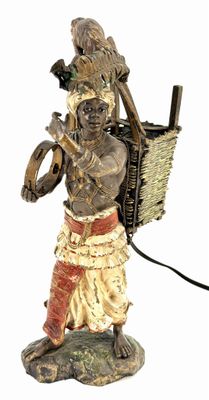 statue of a man carrying a basket with a bird on his shoulder
