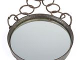 an image of a round mirror with a metal frame and chain around it