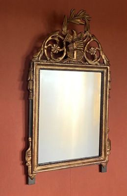 a mirror on the wall above a sink in a bathroom