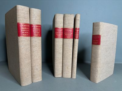 three books sitting on top of each other on a table
