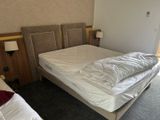 a bed with a white sheet on it in a bedroom