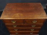 an antique wooden chest of drawers with brass pulls