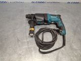 a close up of a corded drill on a metal surface