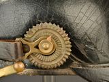 a close up of a leather hat with a metal buckle