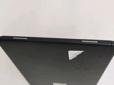the back of a black laptop computer sitting on top of a white table
