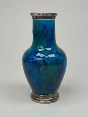 a blue vase that is sitting on a table