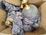 a box with a lamp and a scarf inside of it