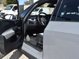 a white car with its door open in a parking lot