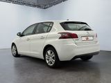 the rear end of a white car parked in a garage