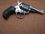 the revolver is sitting on a brown surface with a black handle
