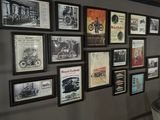 a wall with many pictures on it with a motorcycle