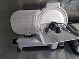 an image of a meat slicer on a table