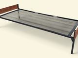 a bed with a metal frame and wood slats