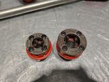 two red knobs that are on a metal surface