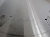 a close up of a metal cutting board with a hole in it