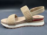 beige sandals with two straps on top of them on a blue surface