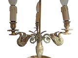 a brass candle holder with two candles on it