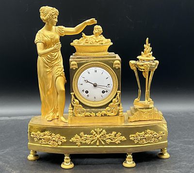 une horloge en or surmontée d'une statue