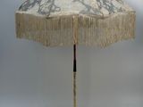 a white umbrella with fringes on it on a white background