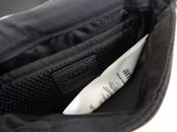 a close up of a black bag with a label in it