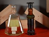 a bottle of liquid next to a bottle of liquor