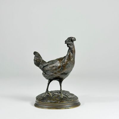 a bronze statue of a chicken standing on a base