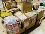 a large amount of boxes stacked on top of each other in a warehouse