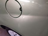 a close up of a car ' s door handle with a hole in it