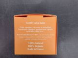an orange box with a label on it sitting on a black surface