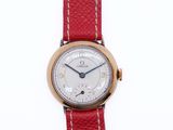 a close up of a wrist watch with a red strap
