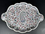 a close up of a plate with a paisley design on it