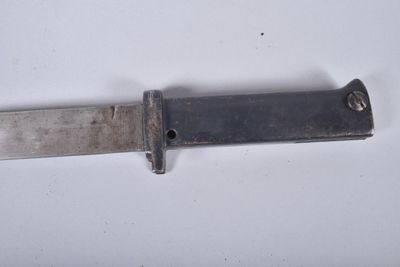 a knife that is laying on a white surface