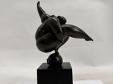 sculpture of a bird on a black base on a white background