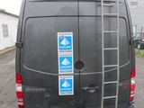 a black van with a ladder on the back of it