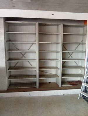 a room with a ladder and shelves in it
