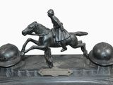 a statue of a man riding a horse with a helmet on