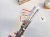 a pair of scissors sitting on top of a table next to a box