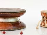 two drums sitting next to each other on a white surface