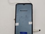 an iphone with a broken screen sitting on top of a white table