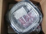 a plastic container with a lid sitting inside of a cardboard box