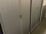 sliding doors in a bathroom with a toilet and a sink