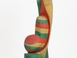 sculpture of a bird made of wood on a white surface